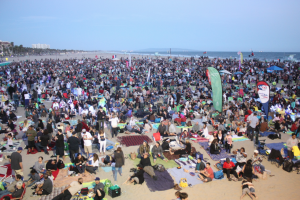 People swarm the beach to relax and listen to the show.