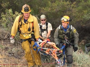 Duron being carried to safety by several rescue personnel.
