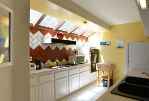 The home's spacious kitchen features a skylight providing it with natural lighting. 