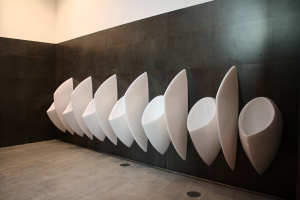 Waterless urinals drain by the way of gravity into the conventional plumbing systems