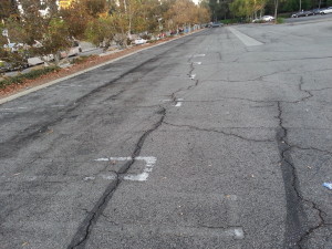 Broken asphalt in the Promenade parking lot.