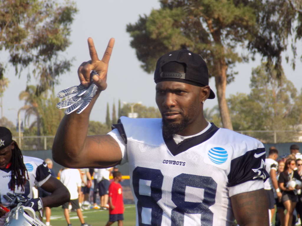 Cowboys and NFL star Dez Bryant gives the peace sign to fans during practice Sunday, July 31. Photo by Michael C. Floch.