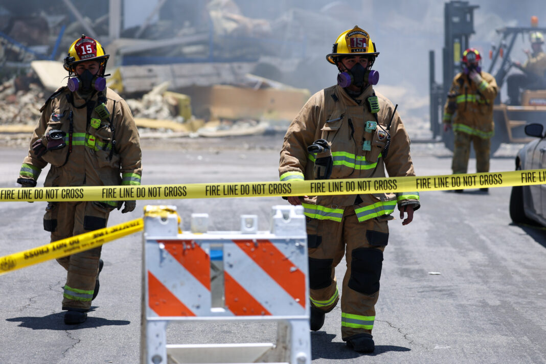 Fire Fighters at work at the Lineage Fire in Boyle Heights Fire Blue collar