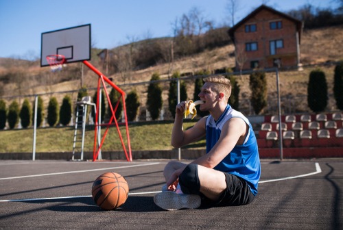Basketball,Player,Eating,Banana,And,Resting